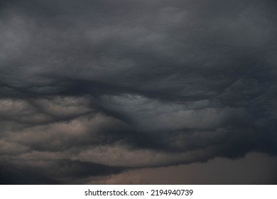 Black, heavy, undulating storm clouds. They are awe-inspiring, foreshadowing the arrival of sudden rains and life-threatening winds. - Shutterstock ID 2194940739