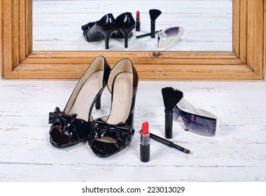 Black Heel Shoes Placed In Front Of A Mirror