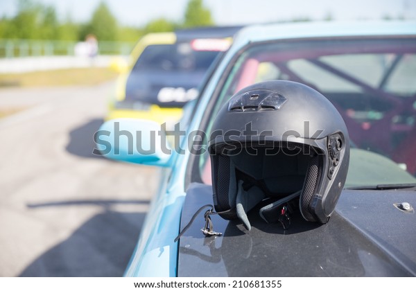 black helmet on hood of\
car