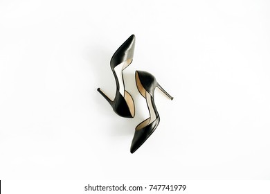 Black high heel shoes on white background. Flat lay, top view.