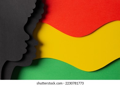 Black History Month color background. African Americans history celebration. Abstract geometric red, yellow, green color background with black paper cut people silhouette. Top view - Shutterstock ID 2230781773