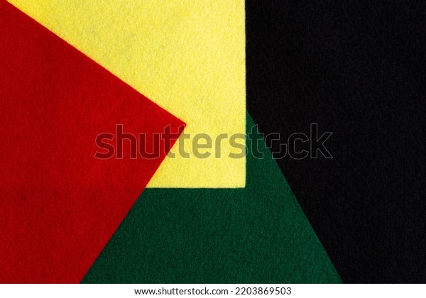 Black History Month color background with copy\
space for text. Geometric felt textile background in black, red,\
yellow, green colors.