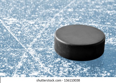 Black Hockey Puck On Ice Rink
