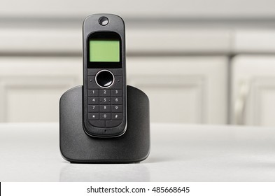 Black Home Cordless Phone Charging On The White Table