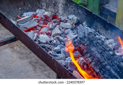 Black hot embers in the grill, lighting the heat for barbecue - Shutterstock ID 2240378397