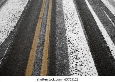 Black Ice And Slippery Frosty Snow Covers The Highway Street. Cold Weather Conditions Are Dangerous Driving Conditions.