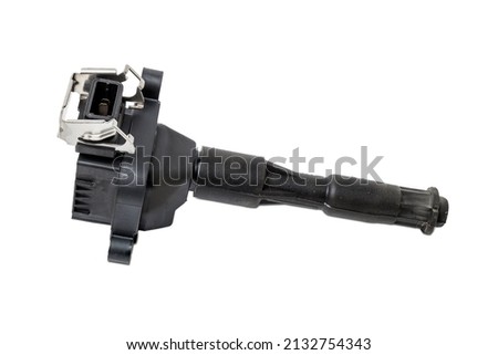 Black ignition coil for engine, isolated on white background. Spare parts for vehicle repair in garage.