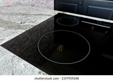 Black Induction Hob on beautiful stone counter top  and black wooden kitchen