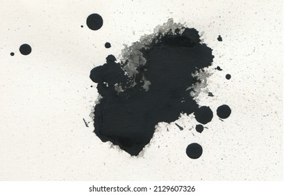 Black ink blot drops on paper texture copy space bakground.
