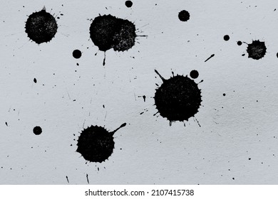 Black Ink Blots On A Textured Paper