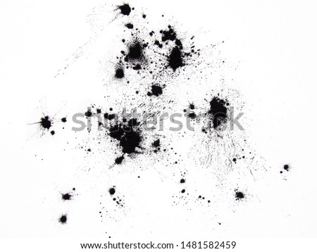 Black ink spots on a white background.          