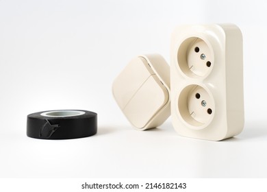 black insulating tape, double socket and two-key light switch on white background. mechanical device for switching lighting circuit, two sockets connected by monolithic case.shop of electronic devices