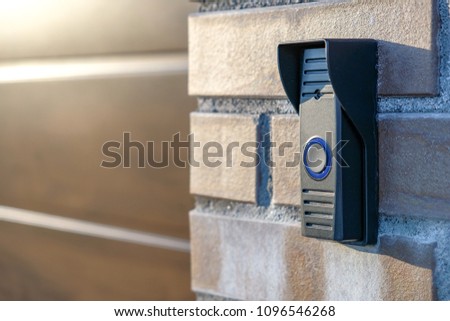 black intercom on a brick wall on garage entry