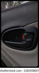 A Black Interior Door Handle With Black And Gray Base Colors On An Automatic Car.
