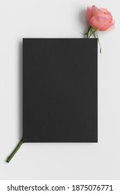 Black invitation card mockup with a pink rose. 5x7 ratio, similar to A6, A5.