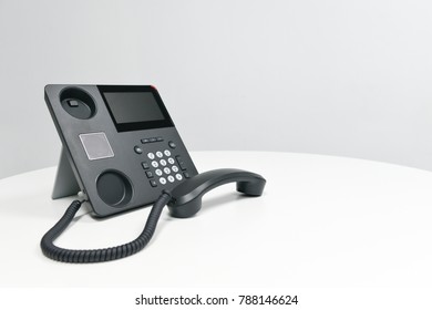 Black IP Phone, Office phone on the white table in the meeting room