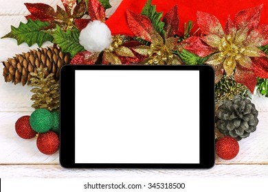 A Black Ipad Tablet Computer With Blank White Screen On Top Of Glittery Christmas Decoration On White Wooden Background