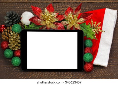 A Black Ipad Tablet Computer With Blank White Screen On Top Of Glittery Christmas Decoration On Brown Wooden Background