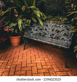 Black Iron Metal Bench On Orange Brick