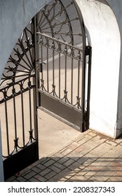 Black Iron Open Gate Cast Shadow On Ground