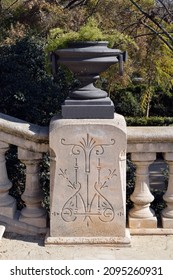 Black Iron Urn On Carved Stone Plinth 