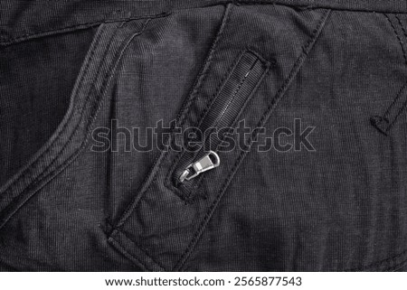 Black jeans texture with sewing pattern  and zipper, abstract close up backdrop
