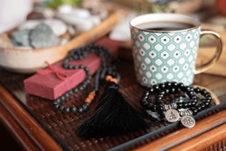 Black Jewellery Made Of Semi Precious  Stones, Bracelets And Japa Mala On The Table With Cup Of Coffee, Boho Style