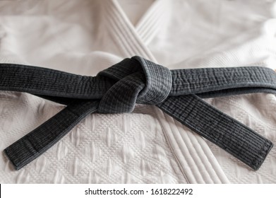 Black judo, aikido or karate belt, tied in a knot