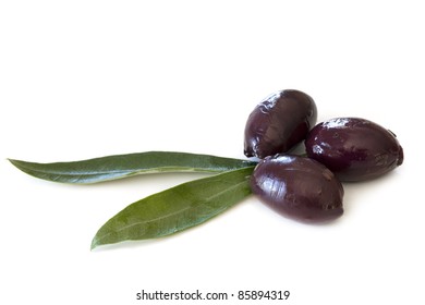 Black Kalamata Olives With Olive Leaves, Isolated On White.