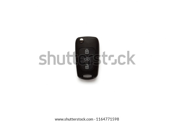 Black key ring with car key with remote control\
over white backg