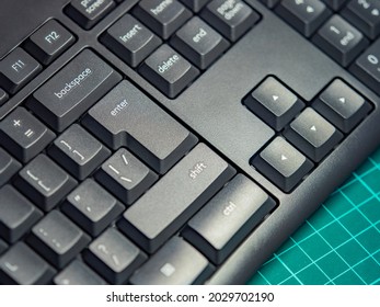 Black keyboard close-up. Control and movement keys on the pc. Backspace, enter, shift, delete and insert keys. Arrow keys. Computer peripherals. Work on a personal computer.