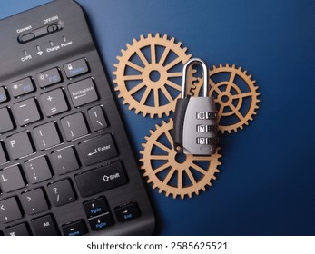 Black keyboard,wooden gear and padlock on blue background. Cybersecurity concept.