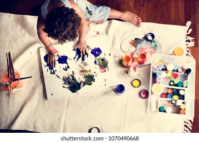 Black Kid Enjoying His Painting