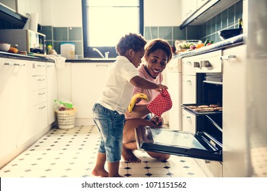 Black Kid Helping Mom Baking Cookies