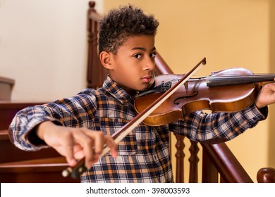 Black Kid Playing Violin. Boy Plays Violin On Stairs. High Notes And Beautiful Sound. Young Violinist's Solo.