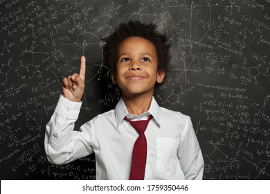 Black Kid Student Pointing At Science Formulas On Chalkboard