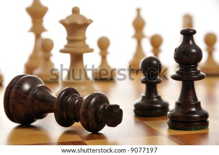 The black king surrendering on a chess board
