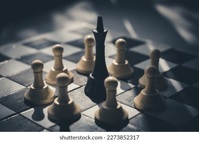 black king surrounded by white pawns on a chessboard. the leader of one team is captured by members of the other team. dictator under siege concept. top view