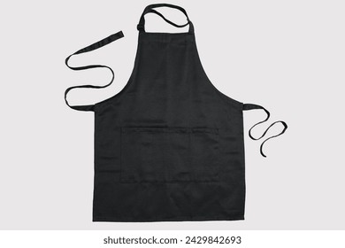 Black kitchen apron background with copy space. Chef black apron, top view