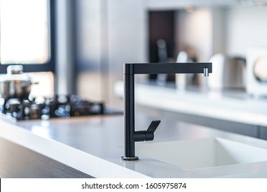 Black Kitchen Faucet With A White Sink In A Stylish Modern Kitchen