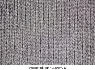 The Black knitted warm fabric texture. Woolen winter warm knitted fabric. Knitted black wool background.Material knitted black thread high definition texture.