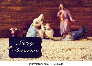 A Black Label With The Text Merry Christmas And The Holy Family In A Rustic Nativity Scene