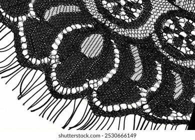 Black lace pattern in close up on a white background