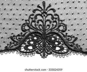 Black lace with a symmetrical pattern. Isolate on white background.