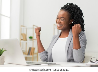 Black Lady Gesturing Yes Sitting At Laptop Celebrating Business Success In Modern Office. Successful Entrepreneurship