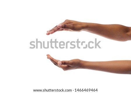 Black Lady's Hands Holding Or Giving Something Invisible Isolated On White Studio Background. Panorama, Empty Space