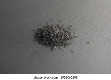Black Lava Hawaiian Sea Salt on dark grey background