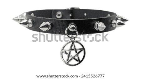 Black leather bracelet with spikes, holnitenes and a pentagram. An accessory for rockers, bikers, metalheads, goths and punks. Steampunk style. Close-up subject photography.