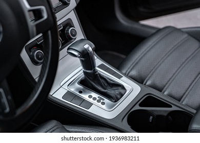 black leather car interior close up.Design details of minimalist concept of modern car - close-up details of automatic transmission and gear stick. car interior - devices, driving concept