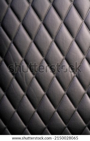 Black leather check pattern interior details of modern luxury sport cars. Comfortable leather cockpit seats for background.